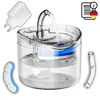A clear, well-lit product shot of a pet water fountain with accessories and informational icons. Produktbild-Vorschau