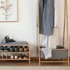 A hallway or entryway scene with a clothing rack and shoe storage bench. Anteprima dell’immagine prodotto
