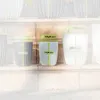 Three plant pots of varying sizes are shown with dimensions overlaid. The pots are placed on a stone surface with a blurred background of more pots. Anteprima dell’immagine prodotto