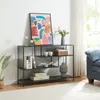 A console table with decorative items and books on it, placed in a living room setting. Náhľad obrázku produktu