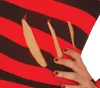 A close-up of a hand with red nail polish touching a striped fabric with claw marks. Produktbild-Vorschau