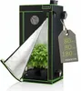 A black and green grow tent with its front flap partially open, revealing plants inside. A cardboard tag with dimensions is attached to the side. Náhľad obrázku produktu