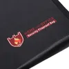 A close-up view of a black fireproof bag with text and a logo printed on it. Produktbild-Vorschau