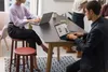 People working on laptops at a table in an office setting. Podgląd zdjęcia produktu