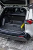 The open trunk of a car with a folded item inside. Produktbild-Vorschau