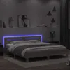 A bed with blue LED lights in a dimly lit bedroom. Produktbild-Vorschau