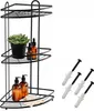 A black metal corner shower caddy with three shelves, holding decorative items and toiletries. Several screws and wall anchors are displayed to the right. Podgląd zdjęcia produktu