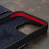 A close-up view of the interior of a dark blue leather iPhone case with a red lining. Produktbild-Vorschau