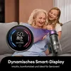 A grandmother and granddaughter are smiling while looking at a vacuum cleaner display. Produktbild-Vorschau