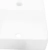A close-up, top-down view of a white ceramic sink with two circular holes. Náhled obrázku produktu