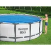 A woman is placing a solar cover on a round above-ground swimming pool in a grassy backyard. Náhled obrázku produktu