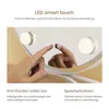 A hand touching a smart touch mirror with LED lights. Produktbild-Vorschau