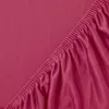 A close-up view of a pink fitted sheet with elasticized edges. Produktbild-Vorschau