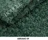 A close-up view of a dark green textured fabric, likely a bedspread or upholstery, with the word 'BOUCLE' overlaid in white text. Produktbild-Vorschau