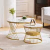 Two round coffee tables with marble-look tops and gold metal frames are placed on a rug in a living room setting. Náhľad obrázku produktu
