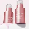Two pink serum bottles with clear caps on a light pink background, with pink liquid dripping from the bottom. Produktbild-Vorschau