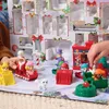 A collection of Paw Patrol advent calendar toys arranged on a festive surface. Podgląd zdjęcia produktu