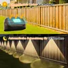 A split image showing solar fence lights. The top half shows a light charging in the sun, and the bottom half shows the lights illuminating a fence at night. Produktbild-Vorschau