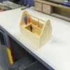 A wooden toolbox kit with tools is placed on a white surface. Produktbild-Vorschau