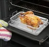 A roasted chicken is being removed from an oven using a roasting rack and pan. Anteprima dell’immagine prodotto