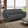 A dark gray sofa is shown in a living room setting with large windows in the background. Voir les images du produit