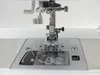 A close-up view of the needle and presser foot of a sewing machine. Náhľad obrázku produktu