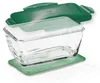 A clear glass food container with a green lid and a green mat underneath. Produktbild-Vorschau