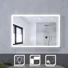 A modern bathroom mirror with integrated LED lighting, displayed against a concrete wall. Below the mirror are three icons illustrating features. Anteprima dell’immagine prodotto