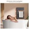 A woman relaxing in a bathtub next to a modern anthracite towel radiator. Produktbild-Vorschau