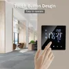 A hand is shown interacting with a smart thermostat mounted on a wall in a modern office or living space. Podgląd zdjęcia produktu