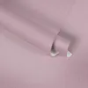 A close-up, angled view of a roll of pink textured wallpaper. Produktbild-Vorschau