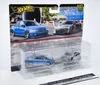 A blister pack containing two Hot Wheels premium die-cast cars, an Audi S4 quattro and an Audi R8 LMS, displayed against a backdrop featuring images of the actual cars. Voir les images du produit