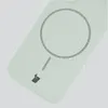 A close-up view of a pistachio-colored silicone phone case with a magnetic ring and a small charging port icon. Produktbild-Vorschau
