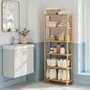 A bathroom scene with a vanity and a tall bamboo shelf unit filled with various bathroom items. Produktbild-Vorschau