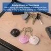 A wooden surface with several keychains and a smartphone. Podgląd zdjęcia produktu