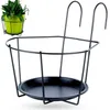 A black metal balcony railing planter holder is shown against a white background. A small inset image shows a green pot with a plant inside the holder. Podgląd zdjęcia produktu