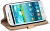 A white Samsung Galaxy S3 Mini smartphone is shown in a tan leather wallet case. Produktbild-Vorschau