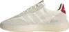 A side view of a white Adidas sneaker with beige suede accents and a red heel tab. Produktbild-Vorschau