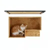 An orange and white cat is resting inside a wooden cat house. Náhled obrázku produktu
