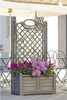 A planter with flowers on a patio with tables and chairs. Anteprima dell’immagine prodotto