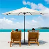 Two people relaxing on lounge chairs on a beach under a large white umbrella. Produktbild-Vorschau