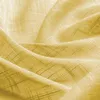 A close-up view of yellow fabric with a subtle grid pattern. Voir les images du produit