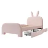 A pink upholstered twin bed with bunny ear headboard and two pull-out storage drawers, shown against a white background. Anteprima dell’immagine prodotto