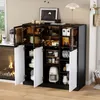 A black and white sideboard with glass doors, filled with various kitchen items and decor, is shown in a room setting with a fireplace and a window. Produktbild-Vorschau