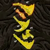 A collection of golden weapon accessories, likely for a toy or game, displayed against a dark, textured background. Produktbild-Vorschau