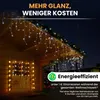 Christmas lights on a wooden house roof and window at night. Produktbild-Vorschau