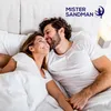 A couple lying in bed, smiling at each other. Voir les images du produit