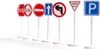 A line of miniature traffic signs on white stands against a white background. Produktbild-Vorschau
