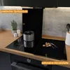 A modern kitchen countertop with a glass stovetop cover and a pot on the stove. Produktbild-Vorschau