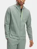 A man wearing a green hooded jacket and matching pants. Produktbild-Vorschau